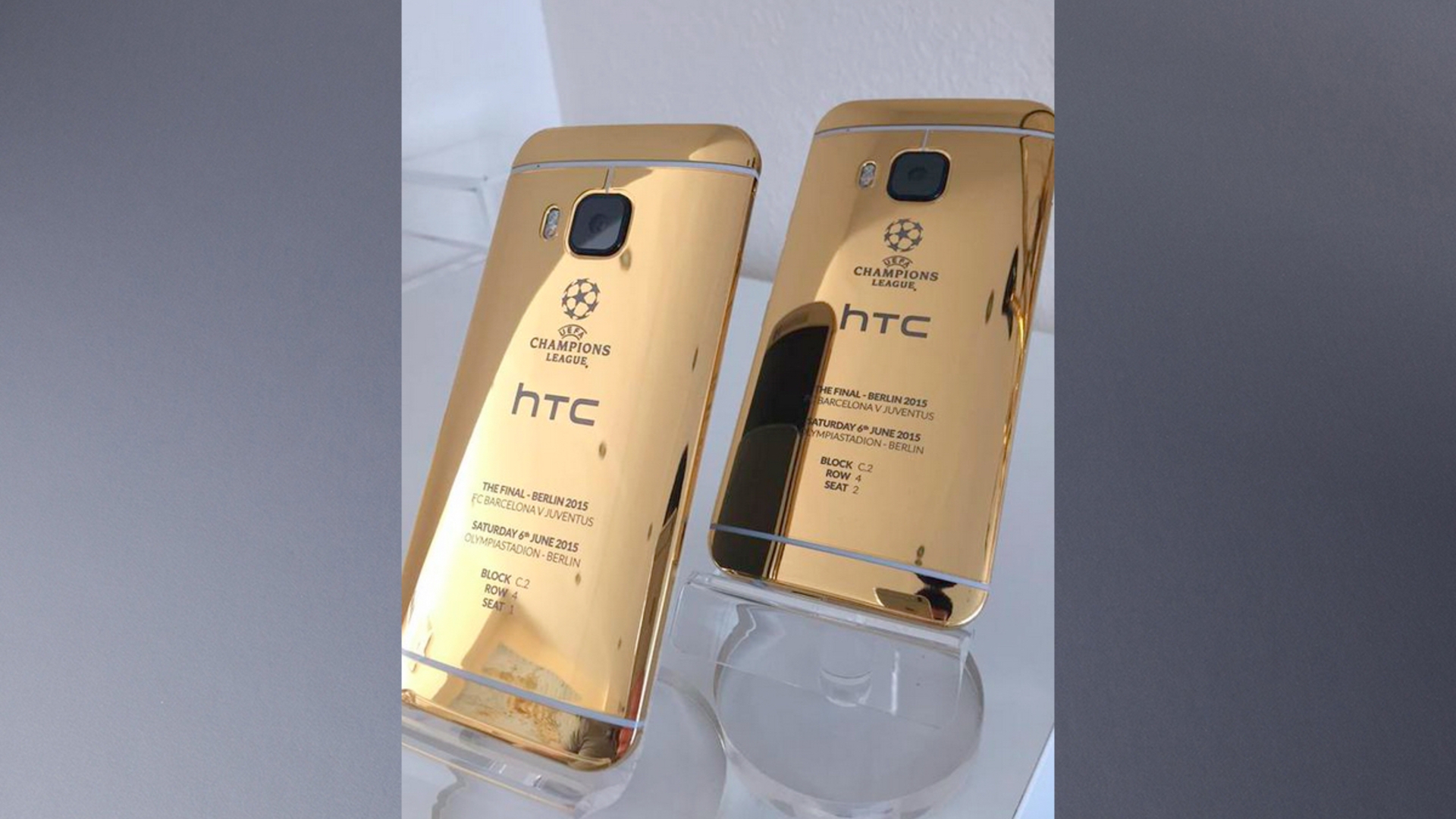 Rechts unten spiegelt sich ein iPhone 6 im Goldgehäuse des HTC One M9